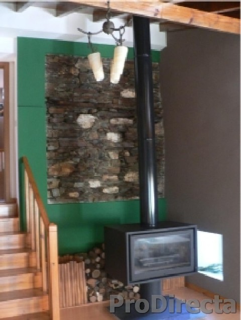 Living Room – Custom Made Double Wall Insulated Chimney System and Wood Burning Stove with Glass Doors Front and Back. Custom Designed and Built Firewood Box